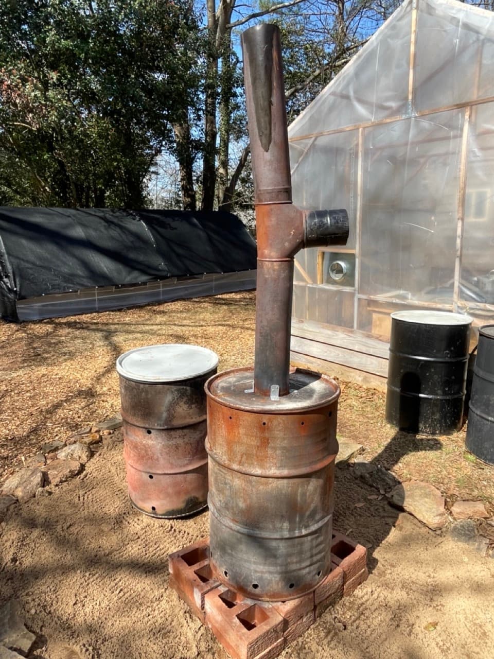 A barrel containing black biochar made from biomass.
