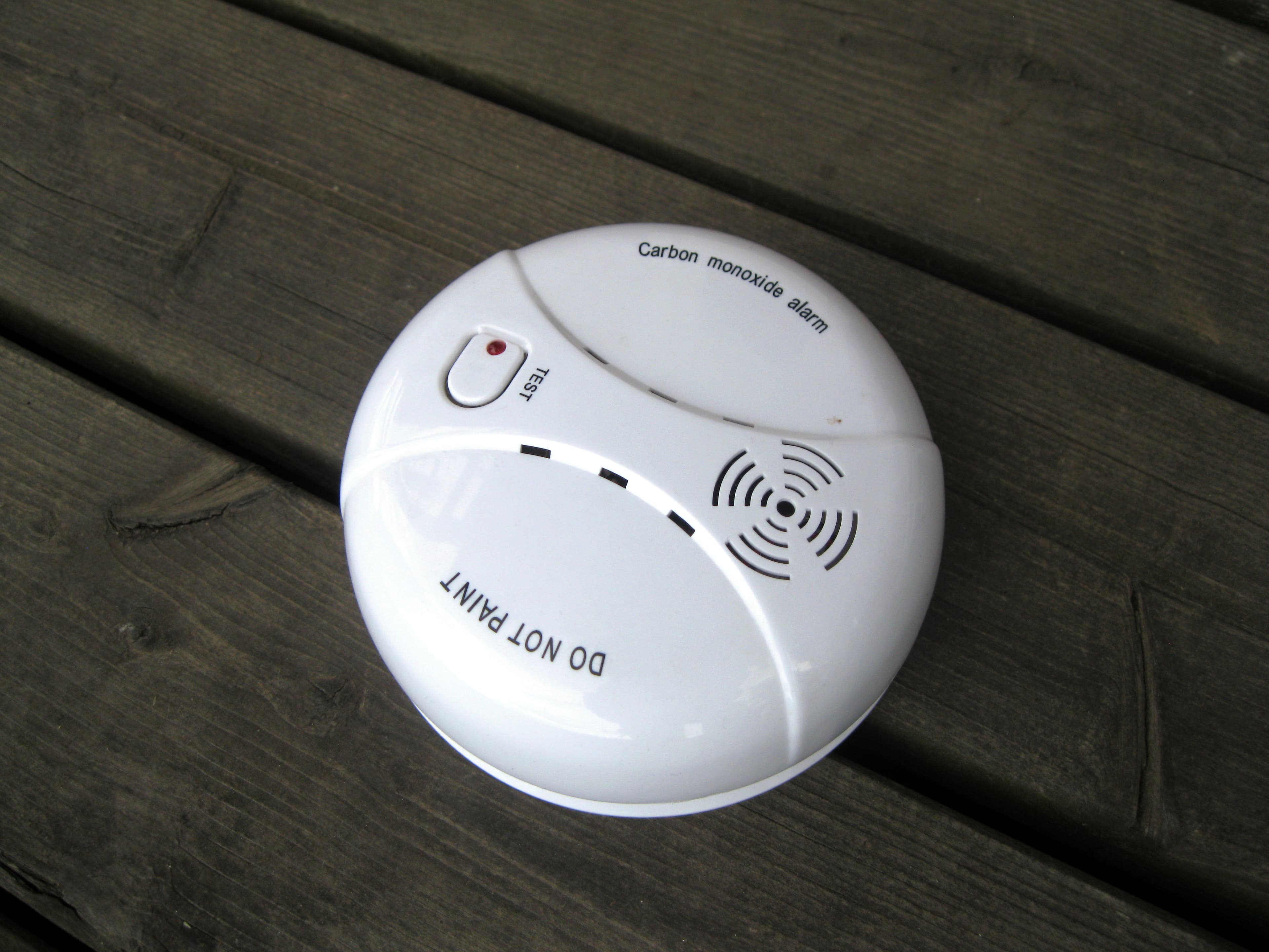 A household carbon monoxide alarm mounted on a wall.