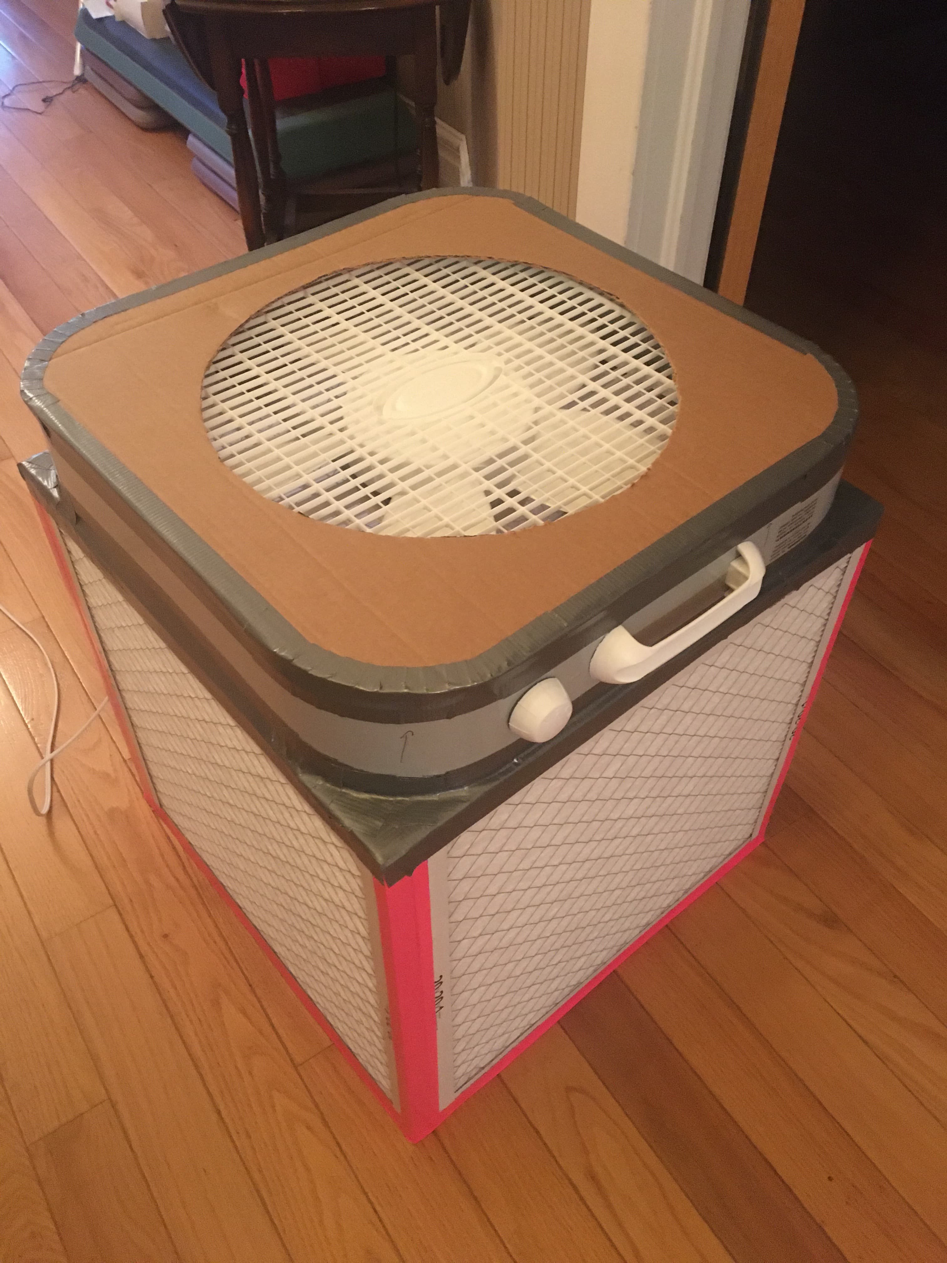 A Corsi-Rosenthal box air filter made from filters, tape, and a box fan.