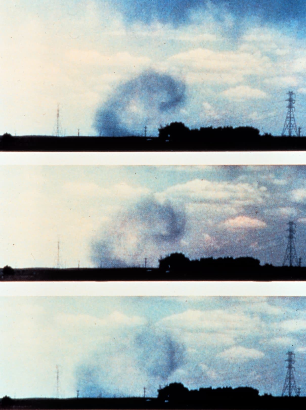 NOAA diagram showing a microburst downdraft descending from a thunderstorm and spreading outward at the ground.