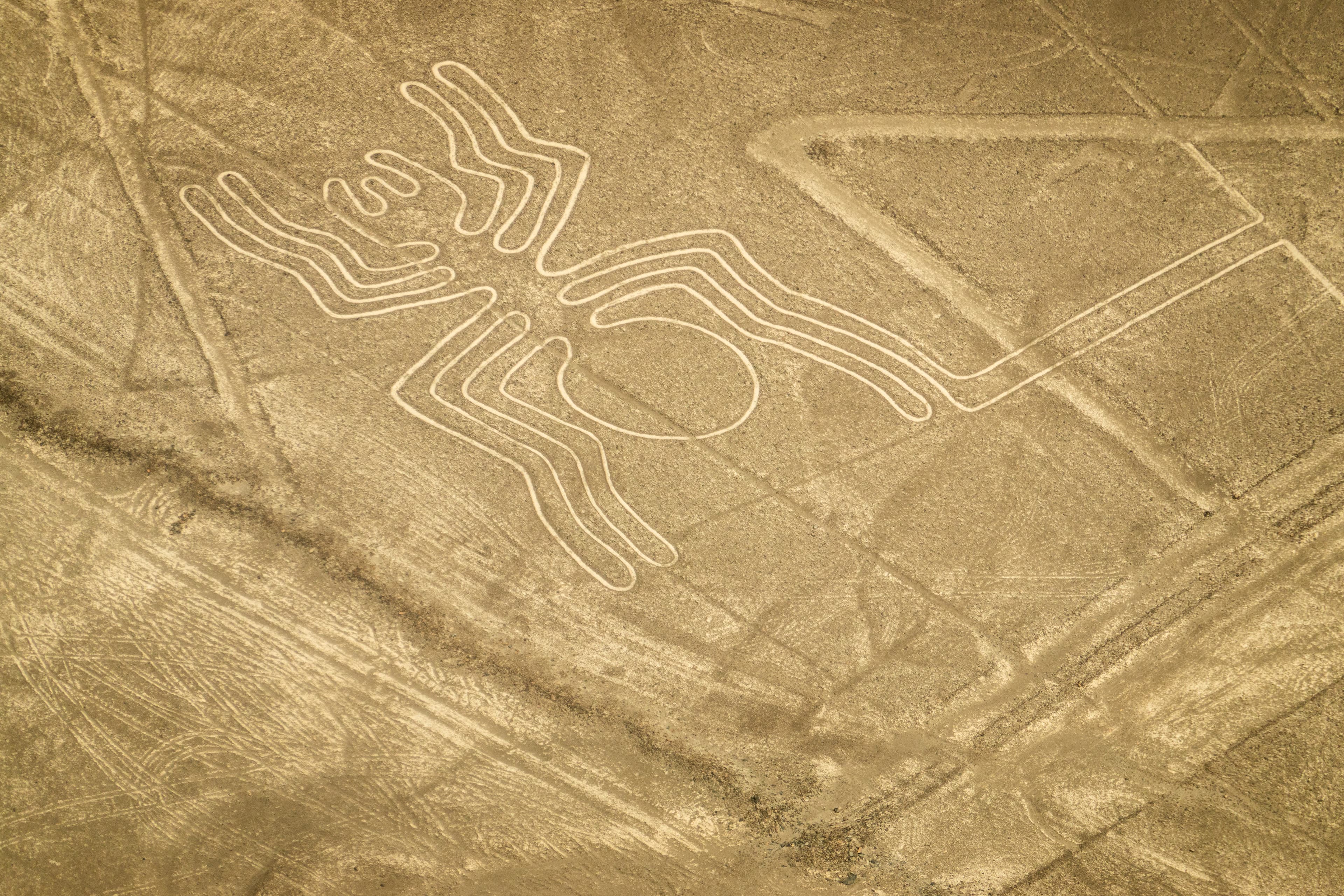 Aerial view of the spider geoglyph among the Nazca Lines in the Peruvian desert.