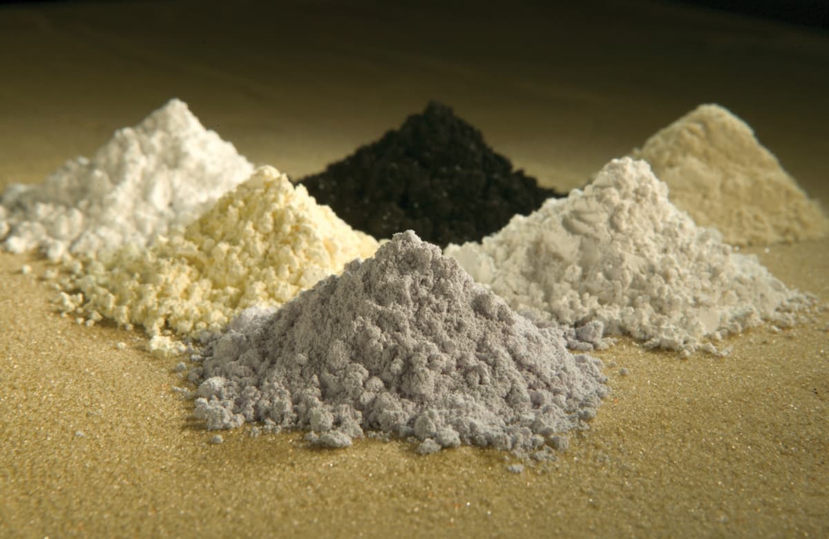 Small jars of differently colored rare-earth oxide powders