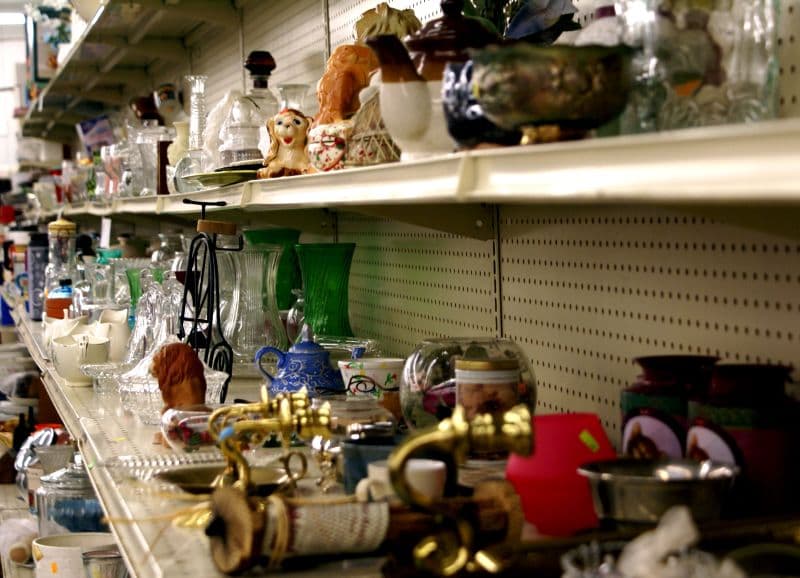 Shelves of secondhand goods displayed in a thrift store.