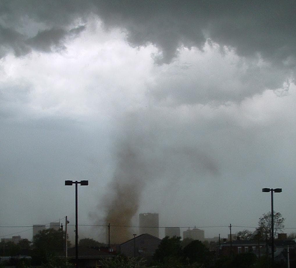 A tornado near Louisville, Kentucky, with rotating debris but no visible condensation funnel reaching the ground.