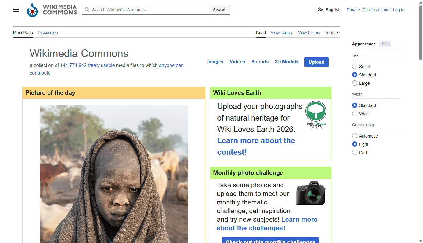 Wikimedia Commons homepage screenshot showing the search bar, media categories, upload button, picture of the day, and page controls.